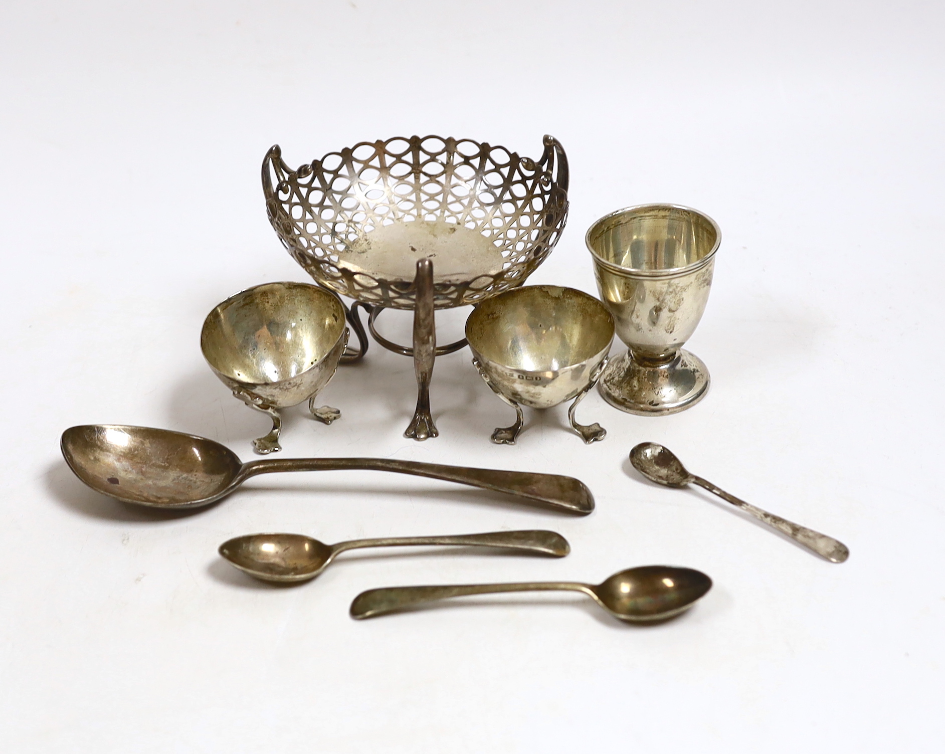An Edwardian pieced silver bonbon dish on raised tripod supports, Birmingham, 1906, height 78mm, two small silver salts, a silver egg cup and four silver spoons, 7.7oz.